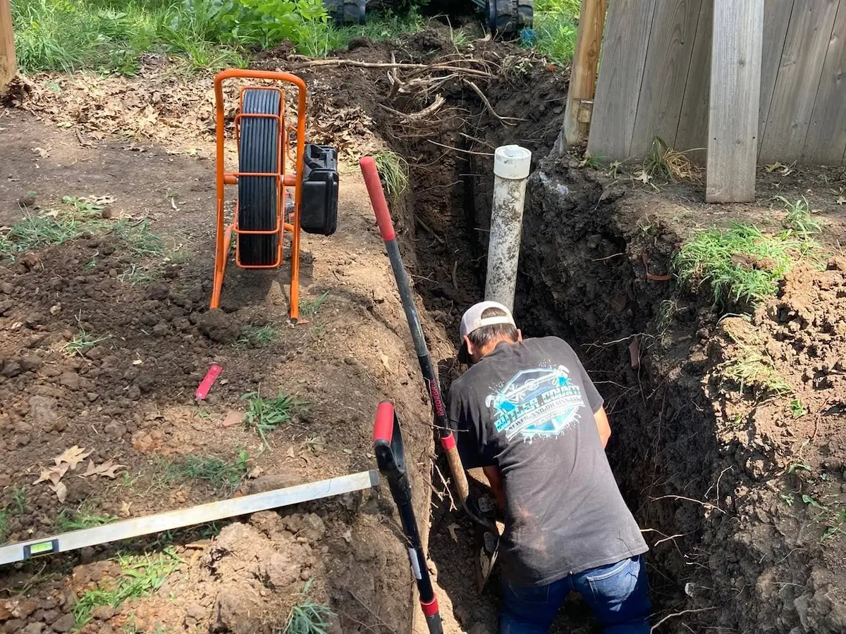 Sewer line repair trench with exposed pipe in Augusta, Kansas